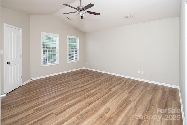 8432 Spirea Ct, Charlotte, NC 28215 - empty room featuring a ceiling fan, wood finished floors, baseboards, and vaulted ceiling
