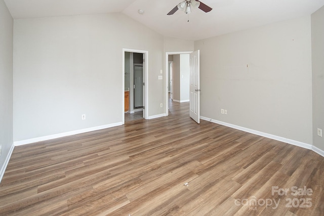 8432 Spirea Ct, Charlotte, NC 28215 - unfurnished bedroom with vaulted ceiling, baseboards, light wood-style floors, and ceiling fan