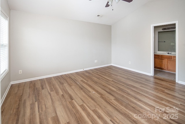 8432 Spirea Ct, Charlotte, NC 28215 - unfurnished room with ceiling fan, light wood-style flooring, healthy amount of natural light, and lofted ceiling