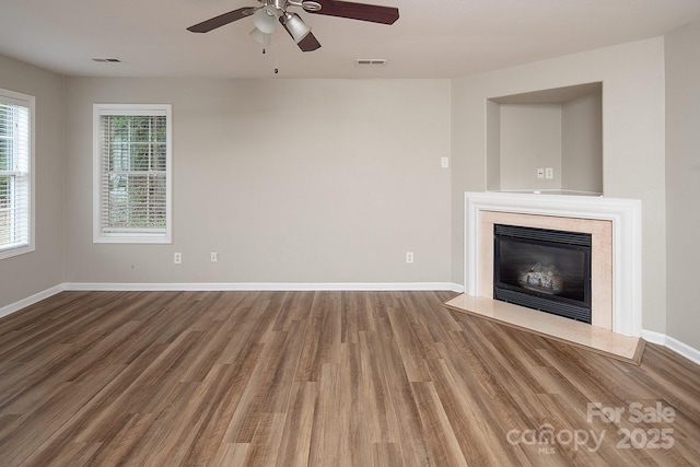 8432 Spirea Ct, Charlotte, NC 28215 - unfurnished living room with wood finished floors, a high end fireplace, ceiling fan, and baseboards