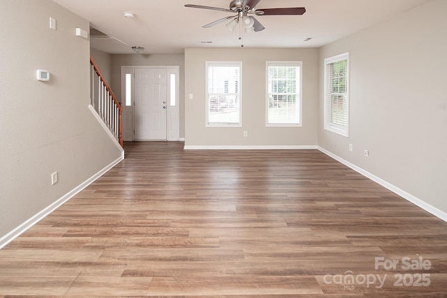 8432 Spirea Ct, Charlotte, NC 28215 - entrance foyer featuring a ceiling fan, baseboards, stairway, and wood finished floors