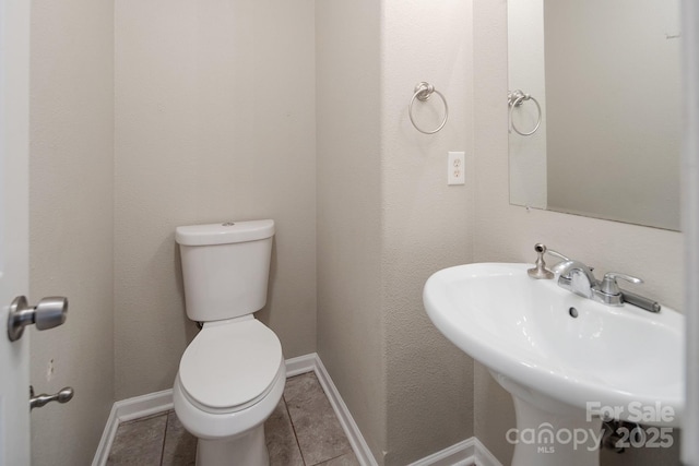 8432 Spirea Ct, Charlotte, NC 28215 - bathroom with toilet, tile patterned floors, a sink, and baseboards