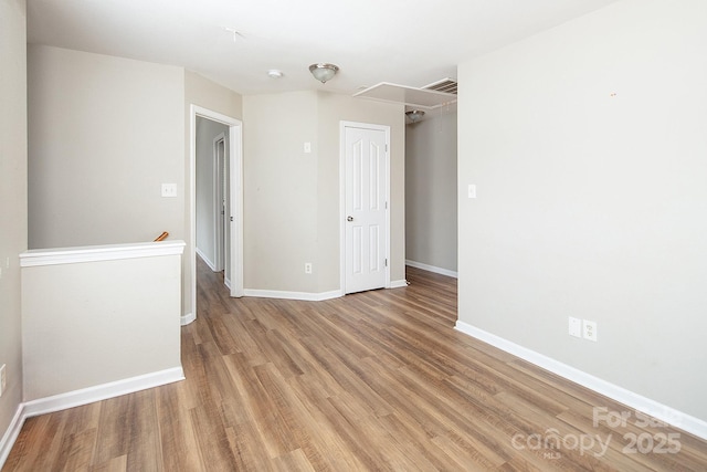 8432 Spirea Ct, Charlotte, NC 28215 - empty room featuring attic access, light wood-type flooring, and baseboards