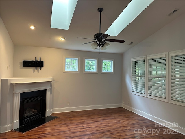 10715 Tom Short Rd, Charlotte, NC 28277 - unfurnished living room with a skylight, dark wood-style flooring, ceiling fan, a fireplace with flush hearth, and recessed lighting