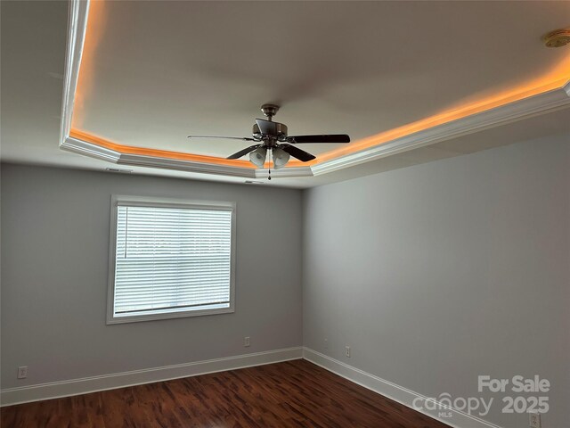 10715 Tom Short Rd, Charlotte, NC 28277 - unfurnished room featuring a raised ceiling, baseboards, ceiling fan, and dark wood-style flooring