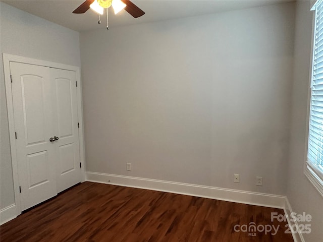 10715 Tom Short Rd, Charlotte, NC 28277 - unfurnished bedroom featuring dark wood-style floors, baseboards, and a ceiling fan