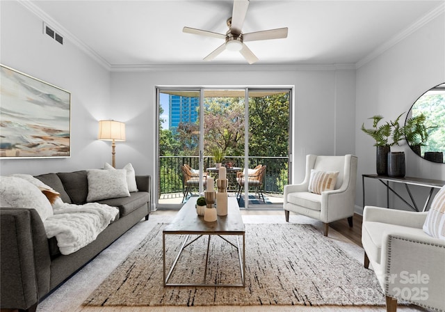 300 W Fifth St Unit 509, Charlotte, NC 28202 - living area with a ceiling fan, crown molding, wood finished floors, plenty of natural light, and baseboards