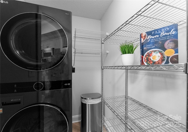 300 W Fifth St Unit 509, Charlotte, NC 28202 - washroom featuring stacked washer / drying machine and a textured ceiling