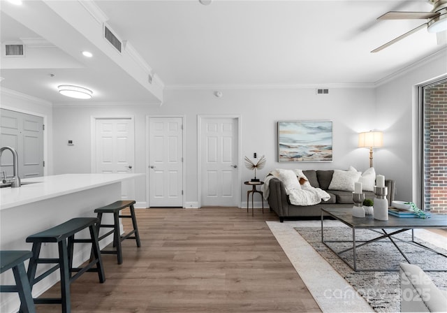 300 W Fifth St Unit 509, Charlotte, NC 28202 - living room with light wood-type flooring, crown molding, ceiling fan, baseboards, and recessed lighting