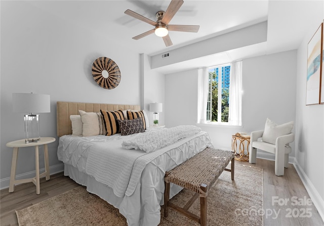 300 W Fifth St Unit 509, Charlotte, NC 28202 - bedroom with wood finished floors, baseboards, and a ceiling fan