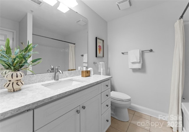 300 W Fifth St Unit 509, Charlotte, NC 28202 - bathroom with vanity, toilet, tile patterned floors, baseboards, and shower / tub combo