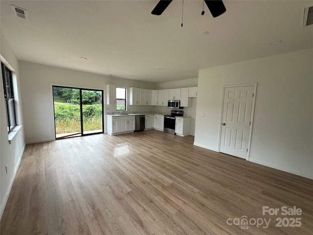 804 3rd Street Pl SW, Hickory, NC 28602 - unfurnished living room with light wood-type flooring, a ceiling fan, and baseboards