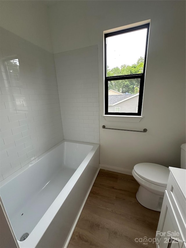 804 3rd Street Pl SW, Hickory, NC 28602 - full bathroom with a tub to relax in, toilet, vanity, wood finished floors, and baseboards