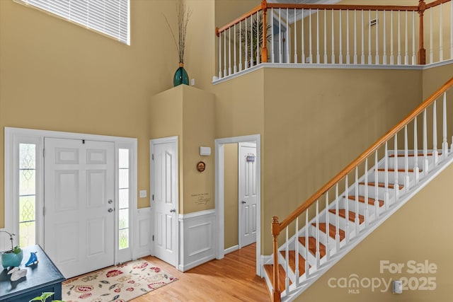 108 Planters Dr, Statesville, NC 28677 - foyer entrance with a towering ceiling, stairs, wood finished floors, and a wainscoted wall