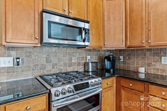 108 Planters Dr, Statesville, NC 28677 - kitchen with stainless steel appliances, tasteful backsplash, brown cabinets, and dark stone countertops