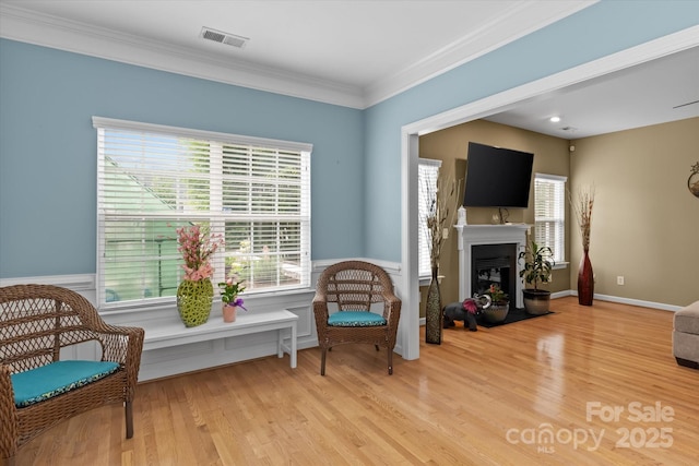 108 Planters Dr, Statesville, NC 28677 - living area featuring a fireplace with flush hearth, wood finished floors, crown molding, and wainscoting