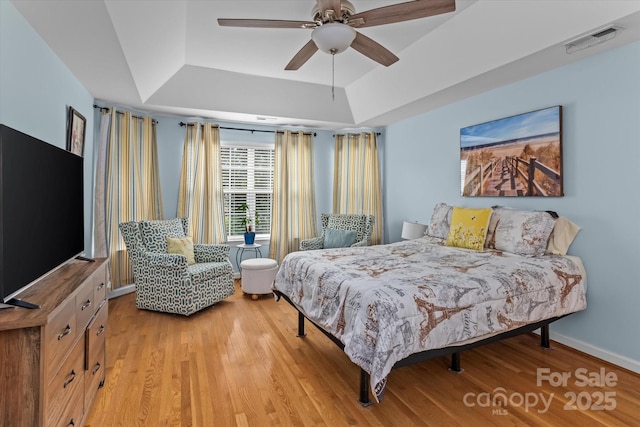 108 Planters Dr, Statesville, NC 28677 - bedroom with a raised ceiling, light wood-style floors, baseboards, and ceiling fan