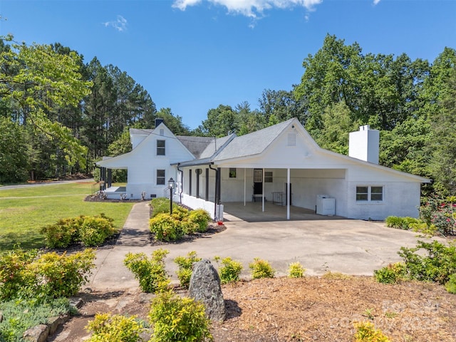 983 Stroud Rd, Ellenboro, NC 28040 - rear view of house featuring a carport, a chimney, a lawn, and asphalt driveway