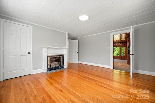 983 Stroud Rd, Ellenboro, NC 28040 - unfurnished living room with crown molding, a brick fireplace, light wood-style flooring, and baseboards