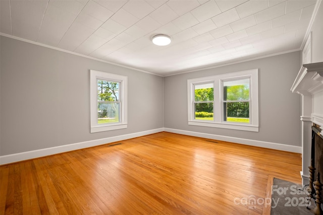 983 Stroud Rd, Ellenboro, NC 28040 - unfurnished living room featuring ornamental molding, a fireplace with flush hearth, baseboards, and light wood-style floors