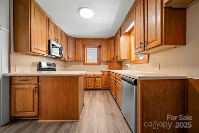 983 Stroud Rd, Ellenboro, NC 28040 - kitchen featuring stainless steel appliances, a sink, light wood-style floors, and light countertops