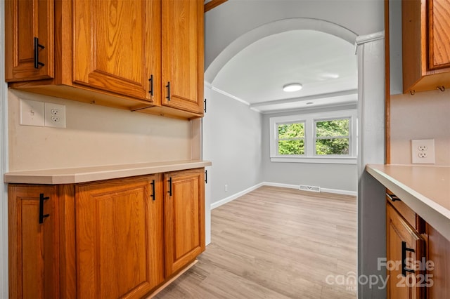 983 Stroud Rd, Ellenboro, NC 28040 - kitchen featuring brown cabinets, light countertops, light wood-type flooring, and baseboards