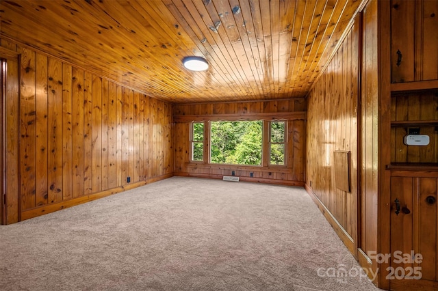983 Stroud Rd, Ellenboro, NC 28040 - unfurnished room featuring wood ceiling, carpet flooring, wooden walls, and baseboards
