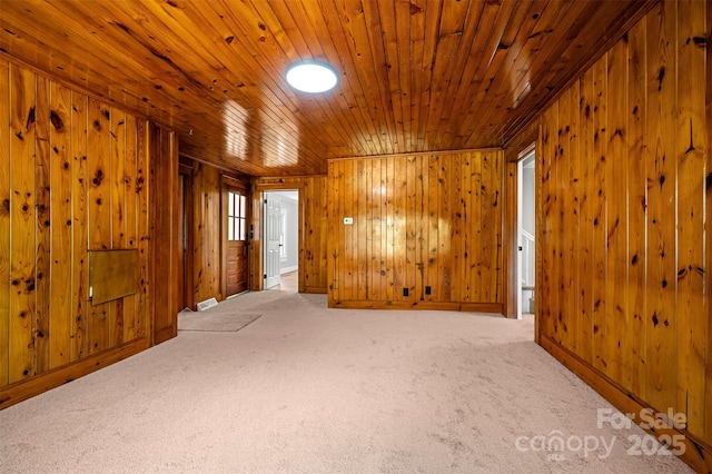 983 Stroud Rd, Ellenboro, NC 28040 - carpeted empty room featuring wood walls and wooden ceiling