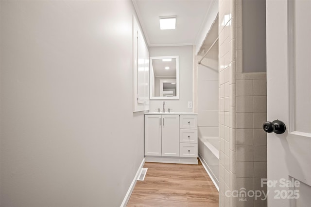 983 Stroud Rd, Ellenboro, NC 28040 - full bathroom featuring vanity, wood finished floors, bathtub / shower combination, ornamental molding, and baseboards