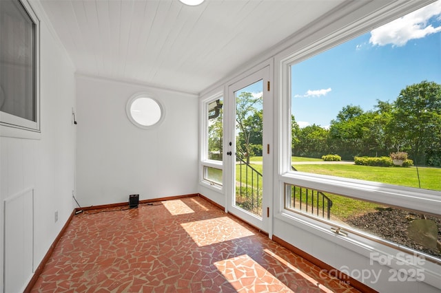 983 Stroud Rd, Ellenboro, NC 28040 - unfurnished sunroom featuring baseboards, stone finish flooring, ornamental molding, and french doors