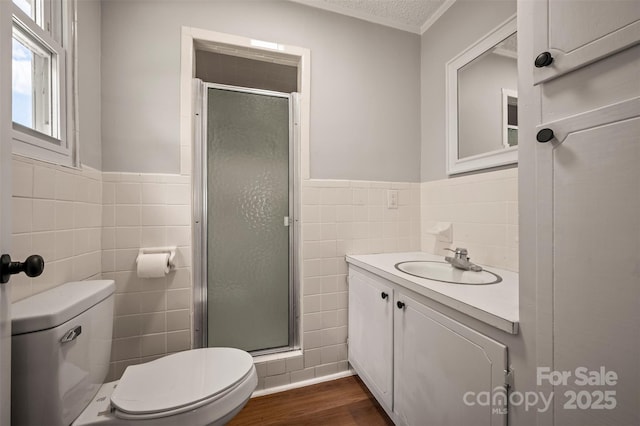 983 Stroud Rd, Ellenboro, NC 28040 - bathroom featuring tile walls, toilet, vanity, wood finished floors, and a shower stall
