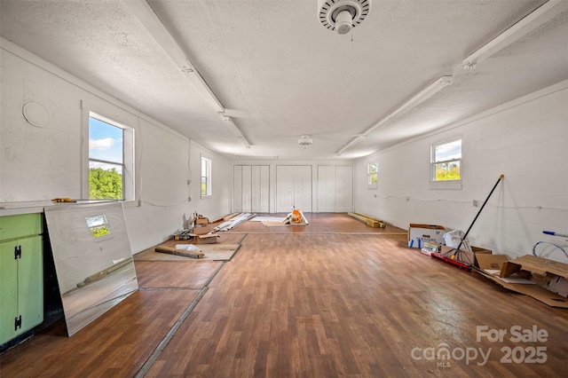 983 Stroud Rd, Ellenboro, NC 28040 - unfurnished room featuring hardwood / wood-style floors, a textured ceiling, concrete block wall, and plenty of natural light
