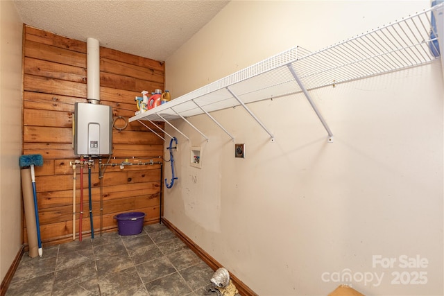 95 Idlewood Dr, Marion, NC 28752 - laundry area with hookup for a washing machine, wooden walls, tankless water heater, hookup for an electric dryer, and baseboards