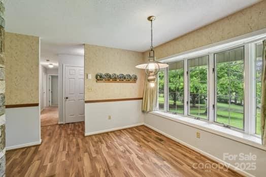 125 Merrill Rd, Fletcher, NC 28732 - unfurnished dining area with wood finished floors and baseboards