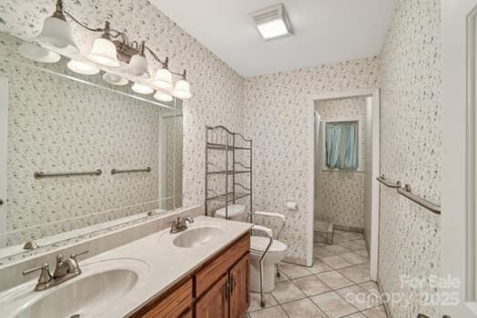 125 Merrill Rd, Fletcher, NC 28732 - full bathroom with toilet, tile patterned flooring, double vanity, and wallpapered walls