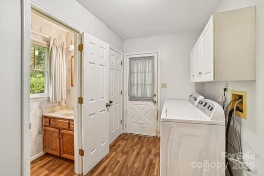 125 Merrill Rd, Fletcher, NC 28732 - laundry room with cabinet space, washing machine and clothes dryer, and wood finished floors