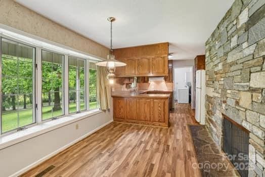 125 Merrill Rd, Fletcher, NC 28732 - kitchen with freestanding refrigerator, light wood-style flooring, a peninsula, and hanging light fixtures