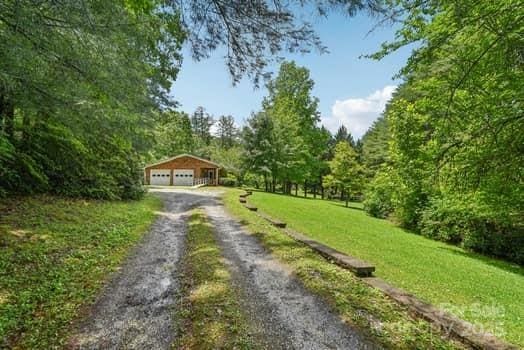 125 Merrill Rd, Fletcher, NC 28732 - view of dirt / gravel driveway featuring a forest view
