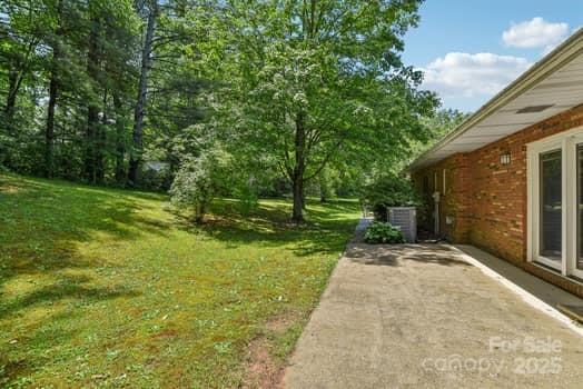 125 Merrill Rd, Fletcher, NC 28732 - view of green lawn featuring central AC and a patio