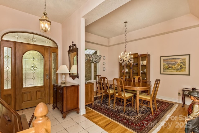 4471 Cove Loop Rd, Hendersonville, NC 28739 - entryway with a chandelier, light tile patterned flooring, baseboards, and a textured ceiling