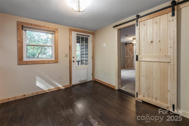 153 Buckner Rd, Black Mountain, NC 28711 - foyer featuring a barn door, dark wood-style flooring, and a textured ceiling