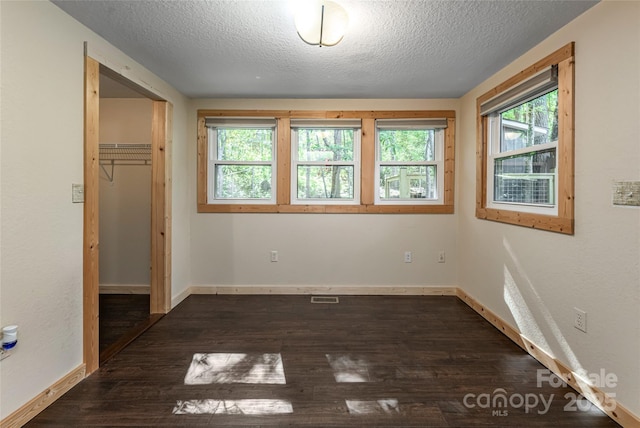 153 Buckner Rd, Black Mountain, NC 28711 - unfurnished bedroom featuring a textured ceiling, dark wood finished floors, and a closet