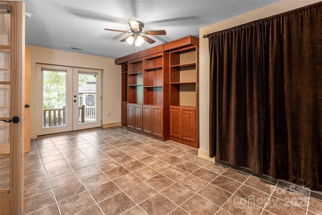 153 Buckner Rd, Black Mountain, NC 28711 - unfurnished living room featuring french doors, ceiling fan, a textured ceiling, and tile patterned flooring