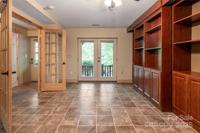 153 Buckner Rd, Black Mountain, NC 28711 - unfurnished dining area with french doors, a textured ceiling, dark tile patterned floors, and ceiling fan