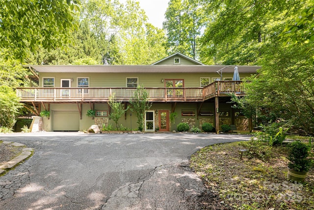 75 Cougar Ln, Saluda, NC 28773 - front of property with driveway, an attached garage, and a wooden deck