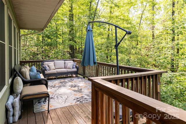 75 Cougar Ln, Saluda, NC 28773 - wooden deck featuring an outdoor living space and a wooded view
