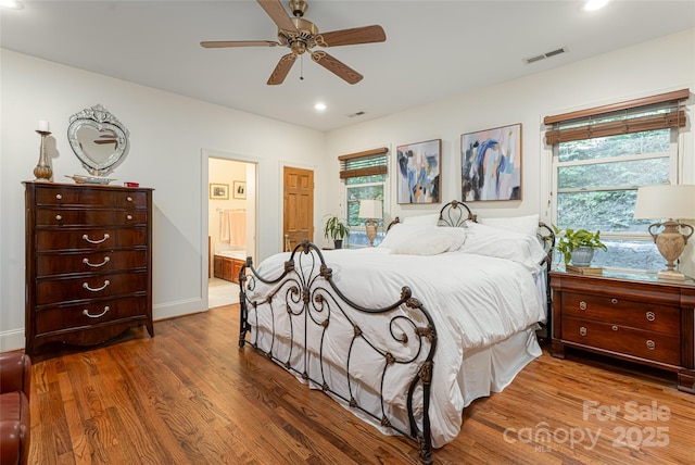 75 Cougar Ln, Saluda, NC 28773 - bedroom with wood finished floors, recessed lighting, baseboards, connected bathroom, and ceiling fan