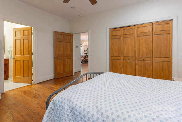 75 Cougar Ln, Saluda, NC 28773 - bedroom featuring light wood-type flooring, a closet, connected bathroom, and ceiling fan