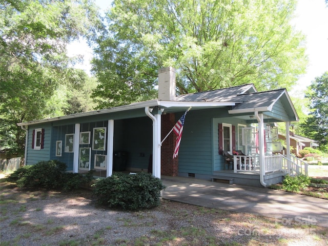 1051 S Brady Ave, Newton, NC 28658 - view of front of home featuring a chimney, covered porch, an attached carport, and crawl space