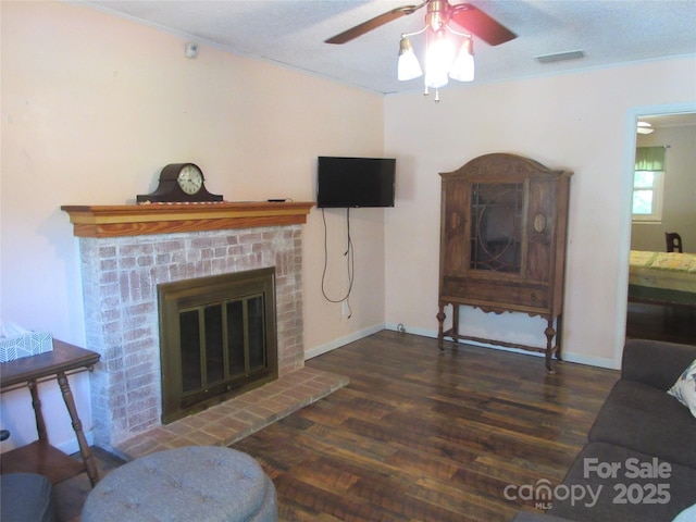 1051 S Brady Ave, Newton, NC 28658 - living area featuring a brick fireplace, wood finished floors, a ceiling fan, ornamental molding, and baseboards